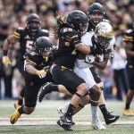 Wake Forest wide receiver Scotty Washington is tackled after a reception and run by App State linebacker Devan Stringer (28) on Saturday in Boone. (Andrew Dye/Winston-Salem Journal)